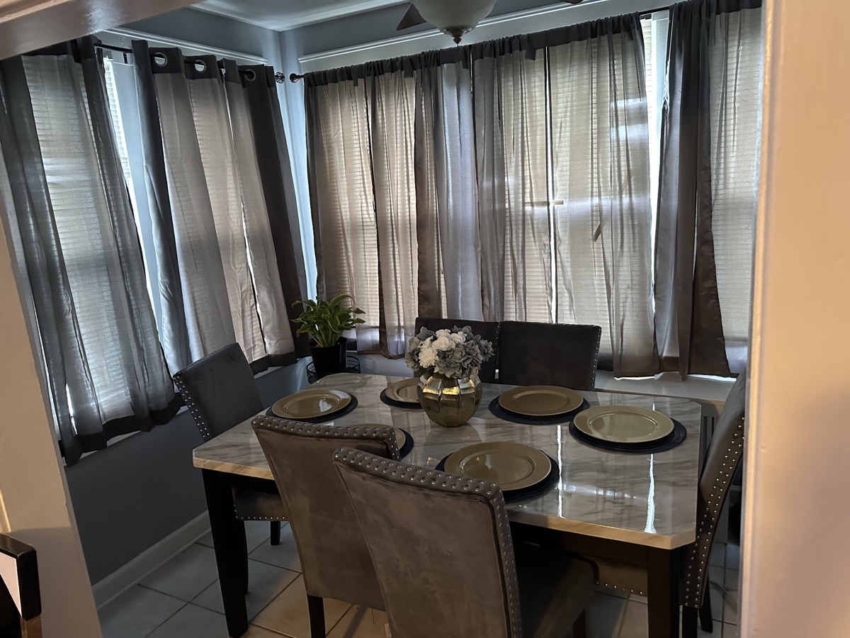 Sunlit dining area with table set for six